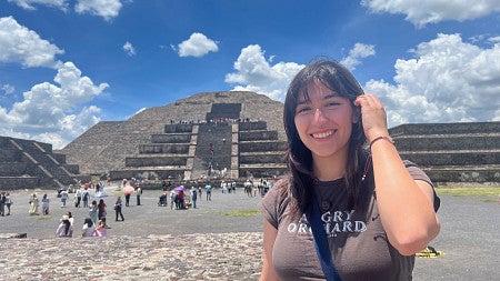 general social sciences major adri jolie standing in front of Chichén Itzá in mexico as part of her study abroad trip