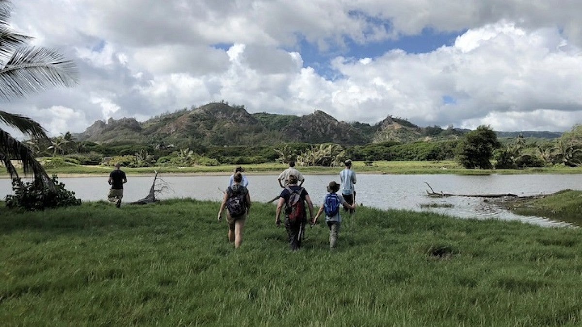 group of people walk to river