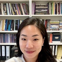 A portrait of Ji-yoon An with a bookcase behind her.