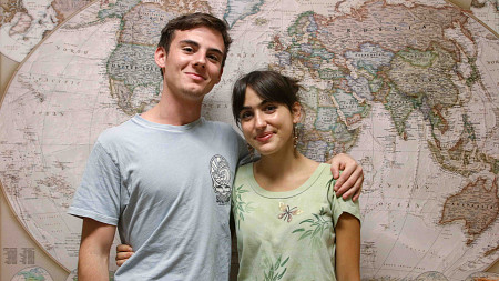 two undergraduates in front of a map